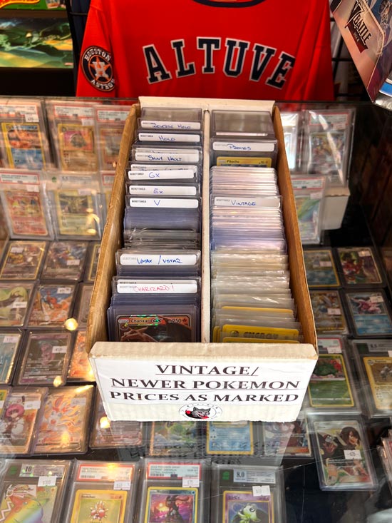 In side our store image with a focus on a box of vintage and newer Pokémon trading cards