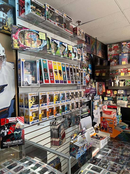 In side our store image with a focus on Pokémon and FUNKO Pops on the shelf behind the counter