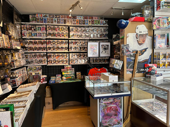 In side our store image with a focus on various items for sale including Pokémon, FUNKO Pops, trading cards and collectibles.