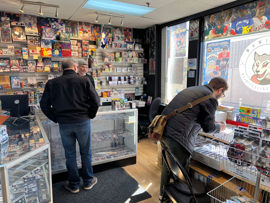 In side our store image with a focus on a father and son looking through our wide selection of cards.